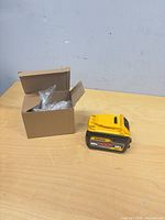 Battery pack beside open cardboard box with bubble wrap