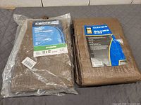 Both tarps folded, showing packaging labels