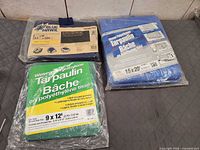 All three packaged tarps grouped