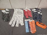 Multiple stacks of packaged paisley headbands sorted by color