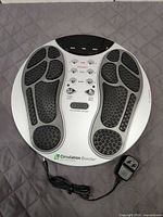 Top view of Circulation Booster foot massager with power adapter