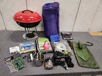 Overview of entire camping gear lot on table