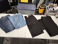 Group view of all denim jeans and shorts on table