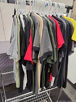 Rack with multiple men’s T-shirts in various colors on hangers