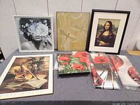 All seven wall art pieces displayed on table