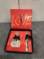 Full gift set in box showing perfume bottle and travel spray