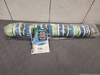 Sealed rolled hammock in plastic wrap with tag visible