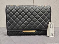 Front view of black quilted Charles & Keith shoulder bag