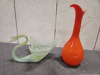 Both art glass items side by side for scale and comparison