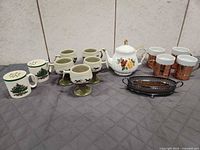 Overview showing teapot, Spode mugs, stoneware pedestal mugs, copper mugs and metal tray