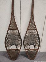 Full view of both wooden snowshoes side by side