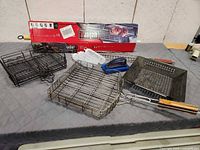 Lot overview showing rotisserie box, spit rod, baskets, pan, injectors, mitt