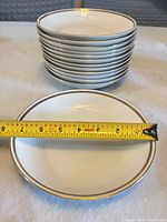 Stack of 13 St. Regis bowls with plate and tape showing diameter