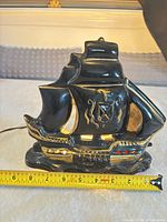 Front view of ceramic sailboat lamp illuminated