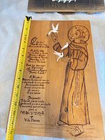 Front of etched wooden plaque with tape for height reference