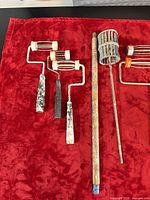 group of roller frames and mixer on red cloth