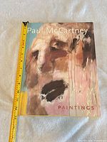 Front cover with measuring tape showing height about 12 inches