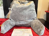 Front view of grey reading pillow with arms and top handle
