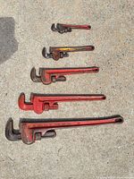 All five Ridgid pipe wrenches laid out by size