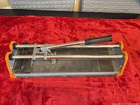 Top view of HDX tile cutter showing rails, scoring carriage and handle