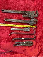All six tools laid out with measuring tape for scale