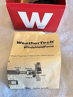Installation manual on top of open red WeatherTech box