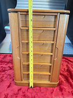 Front view with height tape showing about 15 inches, closed drawers