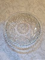 Top view of clear cut glass platter showing overall pattern and scalloped rim