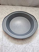 Top view of gray metal pie pan interior showing scratches