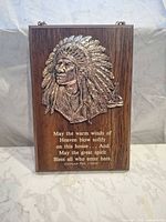 Front view showing metal relief, text and wood grain