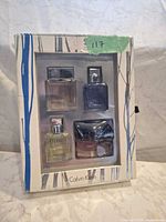 Front view of sealed Calvin Klein mini fragrance set showing four bottles through plastic window