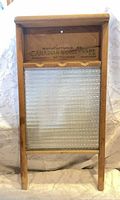 Front view of washboard showing glass panel and stamped maker’s mark