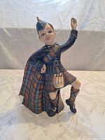 Front view of multicolor tartan Scottish dancer figurine