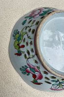 Exterior side showing famille rose decoration and rim wear