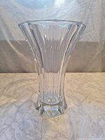 Full view of clear crystal vase showing fluted ribbed sides and hexagonal base