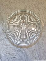 Top view of clear glass platter showing concentric ring pattern and handles