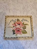 Front view of cream wooden tray with floral and bird motif