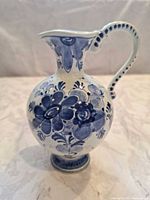 Front view of blue floral porcelain pitcher