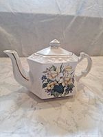 Right side view showing floral decal, shape and gold trimmed spout