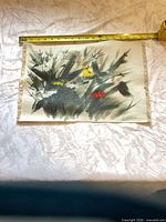 Front view of entire unstretched canvas painting with tape measure showing width