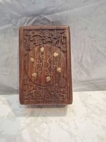 Top view showing carved lid and brass inlay detail