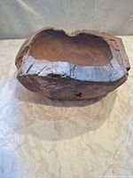 Perspective view of wooden bowl showing natural edge and exterior wear