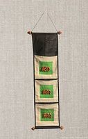 full view of hanging organizer showing three pockets and wood beads