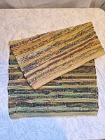 Full view of folded striped rag rug