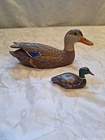 Side view of large hen and small drake wooden mallard decoys