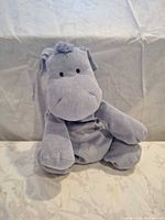 Front view of light lavender hippo plush lovey sitting upright