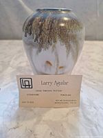 Front view showing glaze pattern and business card identifying artist