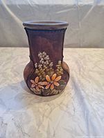 Front view showing floral painting and stitched seams
