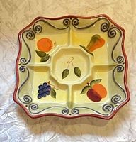 Top view of square divided platter showing fruit motif and glaze