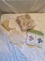 All items laid out: napkins, bun warmer, lace runner, crochet doily
